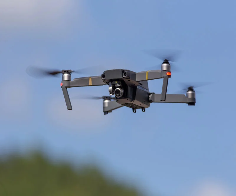 Professional drone in flight recording aerial video footage for business videography
